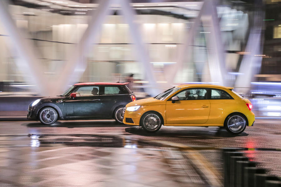 Mini Cooper S JCW and Audi S1 driving through London at night – side tracking