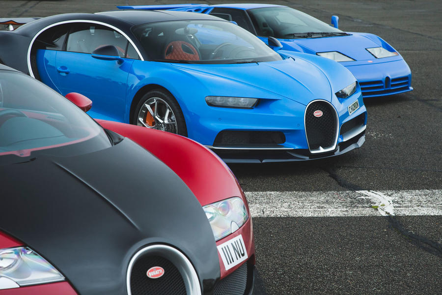 A close-up image of the front of a Bugatti Veyron, parked alongside a Chiron and EB110