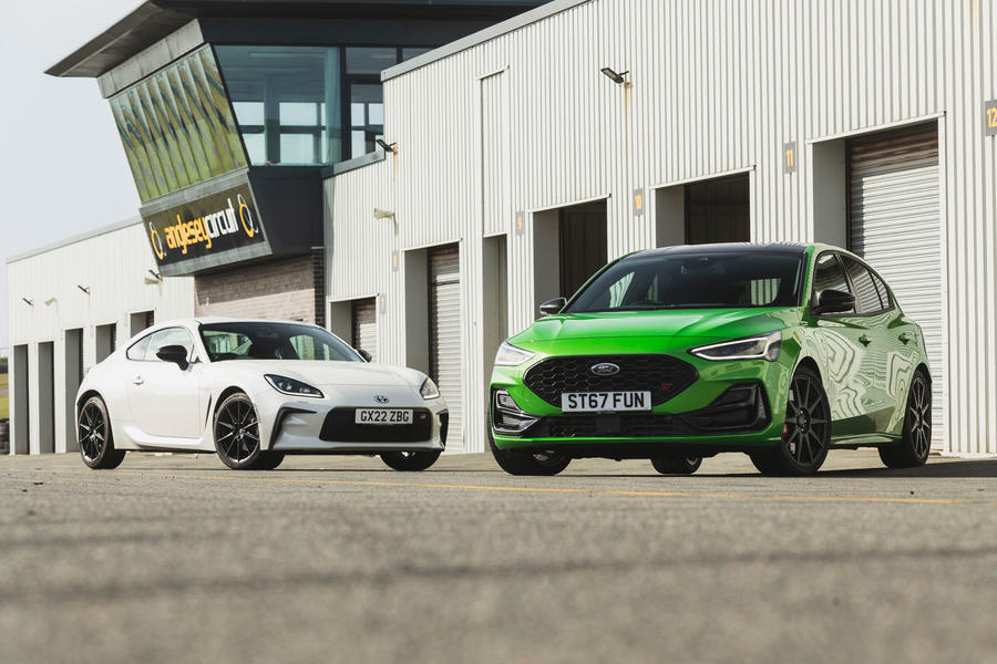Toyota GR86 and Ford Focus ST parked in front of Anglesey garages