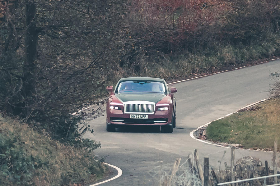 Rolls-Royce Spectre driving through countryside – front