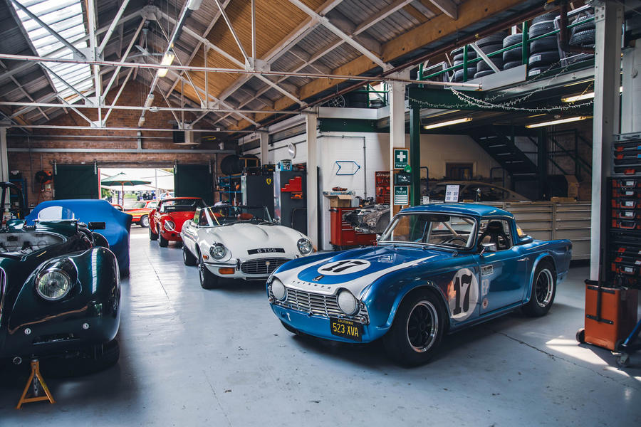 Triumph TR4 parked in Bicester Heritage garage – front quarter