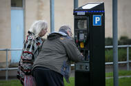 Couple using parking payment machine Getty Images credit Matt Cardy