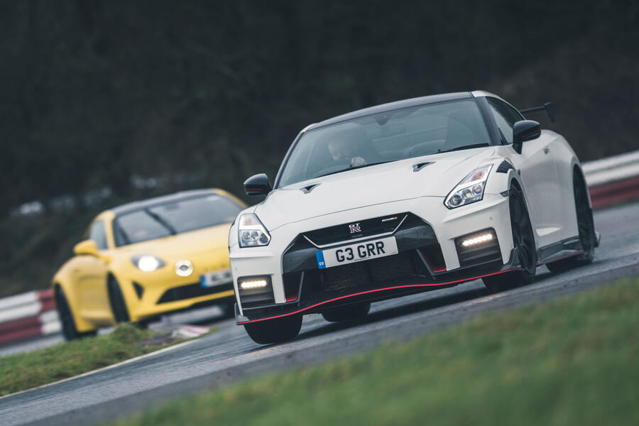 Nissan GT-R Nismo on track, followed by an Alpine A110, viewed from the front